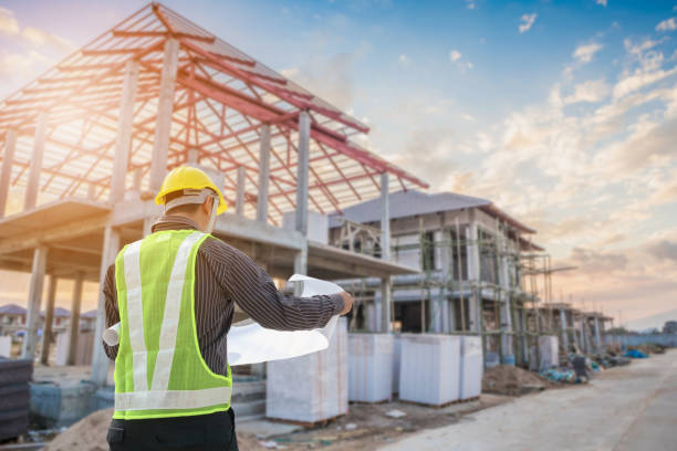 S4 Professional engineer architect worker with protective helmet and blueprints paper at house building construction site background